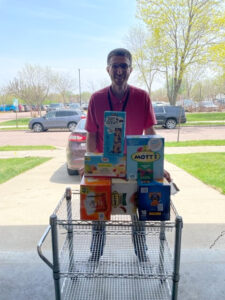 Man with cart full of items for Ronald McDonald House