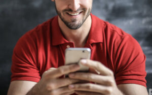 Photo of man texting